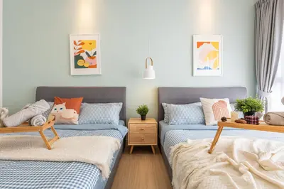 two beds in a room with blue and white at Continew Residensi by Feel Home in Kuala Lumpur