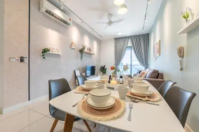 a dining room with a white table and chairs at Continew Residensi by Feel Home in Kuala Lumpur