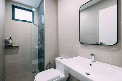 a bathroom with a toilet and a sink and a mirror at Continew Residensi by Feel Home in Kuala Lumpur