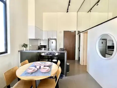a kitchen and dining room with a table and chairs at The EST Bangsar Kuala Lumpur in Kuala Lumpur