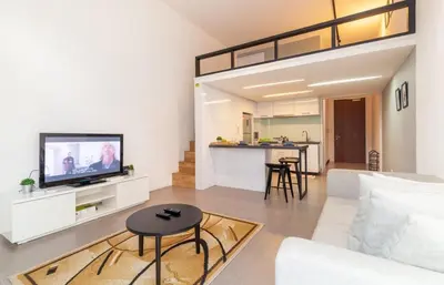 a living room with a couch and a tv at The EST Bangsar Kuala Lumpur in Kuala Lumpur