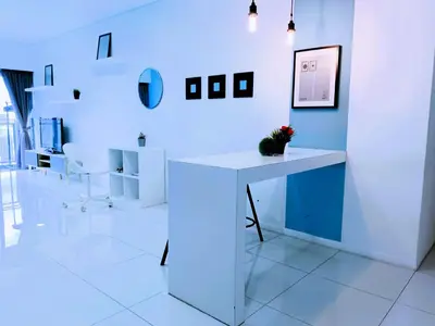 a white room with a white desk in a room at Summer Suites KLCC by Luna KL in Kuala Lumpur