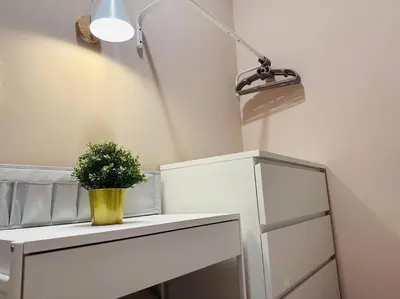 a plant in a yellow vase on a white dresser at MVD19#Family Suite 8pax 3 Rooms M Vertica Velocity Mall Cheras IKEA Mytown Short Walk to MRT & LRT Maluri in Kuala Lumpur