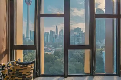 a view of a city skyline from a window at Ceylonz Suites By MyStay in Kuala Lumpur