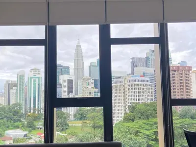 a view of a city skyline from a window at Ceylonz Suites By MyStay in Kuala Lumpur