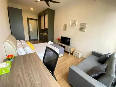 a living room with a couch and a table at Ceylonz Suites By MyStay in Kuala Lumpur