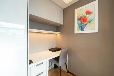 a room with a desk with a chair and a painting at Imperial Luxury Suites KLCC by Moonway in Kuala Lumpur