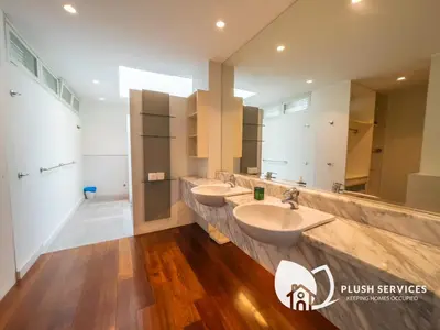 a bathroom with two sinks and two mirrors at Damansara Heights by Plush in Kuala Lumpur
