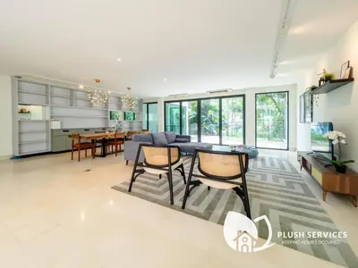 a kitchen and living room with a table and chairs at Damansara Heights by Plush in Kuala Lumpur