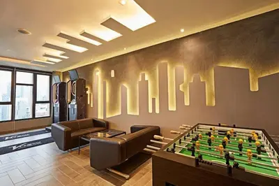 a living room with a pool table and couches at Stylish Ceylonz Suite near Bukit Bintang 4pax in Kuala Lumpur