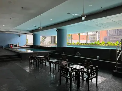 a dining room with tables and chairs in a building at Cozy home in city center with free parking -1B in Kuala Lumpur