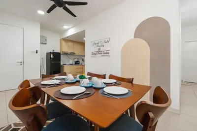 a dining room with a wooden table and chairs at Sentul Homestay 3 Bedroom in Kuala Lumpur