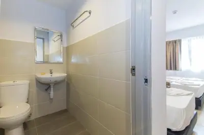 a bathroom with a white toilet and a sink at M HOTEL - Medan Tuanku Near MARA in Kuala Lumpur