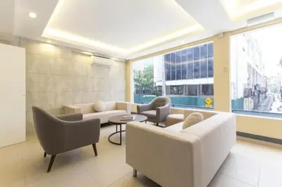 a living room with couches and chairs in a building at M HOTEL - Medan Tuanku Near MARA in Kuala Lumpur