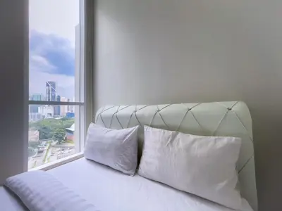 a bed with two white pillows and a window at Soho Suites KLCC 20 jalan perak in Kuala Lumpur