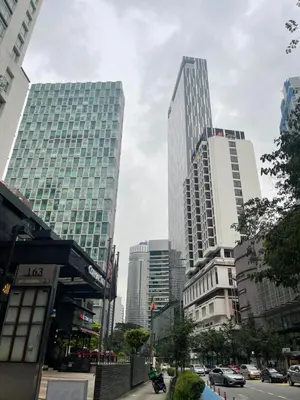 a city with tall buildings and a street with cars at Soho Suites KLCC 20 jalan perak in Kuala Lumpur