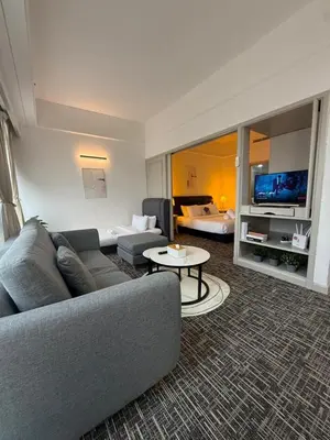 a living room with a couch and a table at Luxhouz Suites at Times Square Kuala Lumpur in Kuala Lumpur