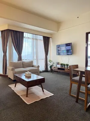 a living room with a couch and a table at Luxhouz Suites at Times Square Kuala Lumpur in Kuala Lumpur