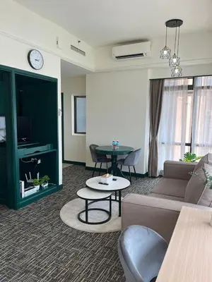 a living room with a couch and a table at Luxhouz Suites at Times Square Kuala Lumpur in Kuala Lumpur
