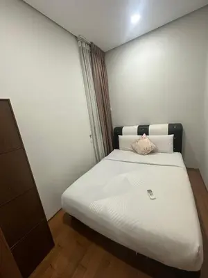 a bedroom with a white bed with a pillow on it at Vortex Suites KLCC by ZARA in Kuala Lumpur