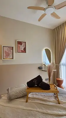 a bedroom with a bed and a ceiling fan at Neu Suites in Kuala Lumpur
