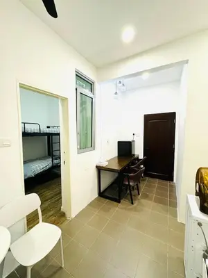 a bedroom with a desk and a bed in a room at Cozy home in city center with free parking - 1A in Kuala Lumpur