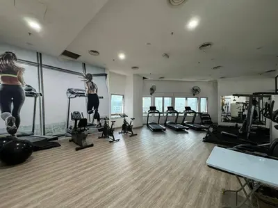 a gym with several people exercising on tread machines at Cozy home in city center with free parking - 1A in Kuala Lumpur