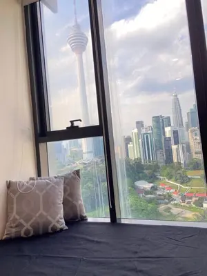 a bedroom with a large window with a view of a city at Ceylonz Suites By Staybliss in Kuala Lumpur