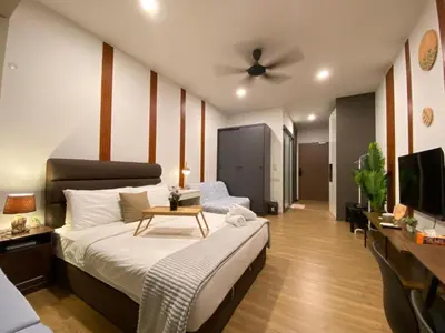 a bedroom with a large bed and a table at Ceylonz Suites By Staybliss in Kuala Lumpur