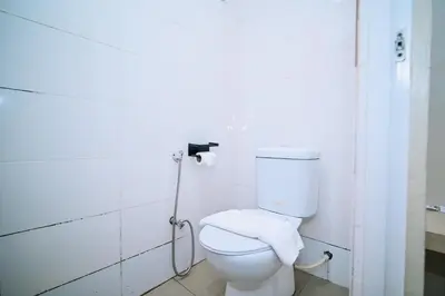 a bathroom with a white toilet in a room at Swing & Pillows - My Home Hotel Wangsa Maju in Kuala Lumpur