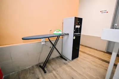 a table in a room next to a refrigerator at Swing & Pillows - My Home Hotel Wangsa Maju in Kuala Lumpur
