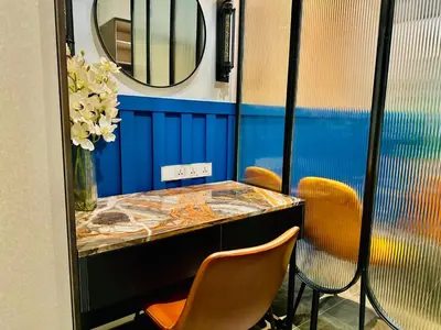 a table with two chairs and a mirror in a room at Scarletz suites klcc Bukit Bintang by lulu in Kuala Lumpur