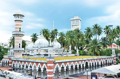 a mosque in a city with palm trees at Cozy home in city center with free parking -1C in Kuala Lumpur
