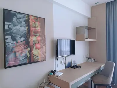 a room with a desk with a tv on a wall at D'Majestic Place in Kuala Lumpur