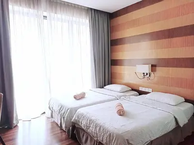 two beds in a hotel room with towels on them at D'Majestic Place, 1 King or 2 Super Single beds in Kuala Lumpur