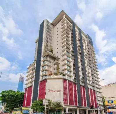 a large apartment building with a red and white facade at D'Majestic Place, 1 King or 2 Super Single beds in Kuala Lumpur