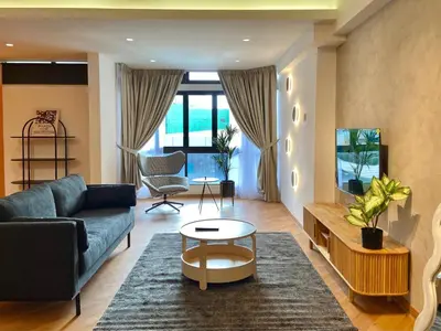 a living room with a couch and a table at KAĨTE Homestay at Fahrenheit88 Bukit Bintang in Kuala Lumpur