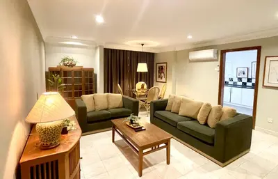 a living room with a couch and a table at KAĨTE Homestay at Fahrenheit88 Bukit Bintang in Kuala Lumpur