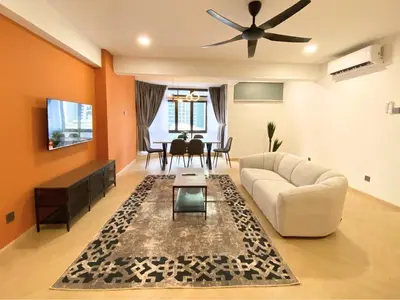 a living room with a couch and a table at KAĨTE Homestay at Fahrenheit88 Bukit Bintang in Kuala Lumpur