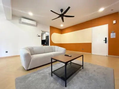 a living room with a couch and a ceiling fan at KAĨTE Homestay at Fahrenheit88 Bukit Bintang in Kuala Lumpur