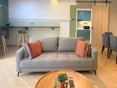 a living room with a couch and a table at KAĨTE Homestay at Fahrenheit88 Bukit Bintang in Kuala Lumpur