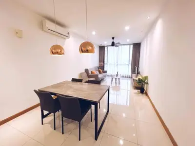 a dining room and living room with a table and chairs at KL Gateway Residences in Kuala Lumpur