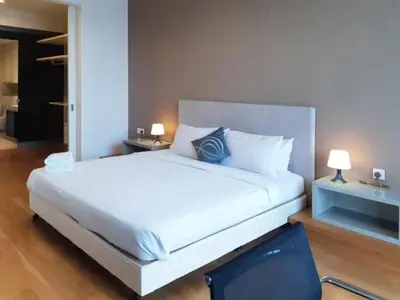 a large white bed in a room with two lamps at The Platinum Kuala Lumpur KLCC By Garden Suites in Kuala Lumpur