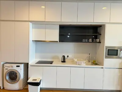 a kitchen with white cabinets and a washing machine at The Platinum Kuala Lumpur KLCC By Garden Suites in Kuala Lumpur