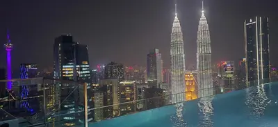 a view of a city skyline at night at Imperial Suites KLCC in Kuala Lumpur