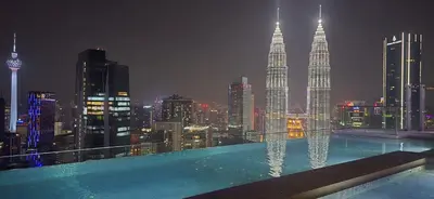 a swimming pool on top of a building with a city skyline at Imperial Suites KLCC in Kuala Lumpur