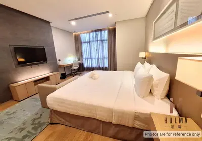 a hotel room with a large bed and a television at 188 Suites KLCC by Holma in Kuala Lumpur