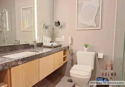 a bathroom with a toilet and a sink and a mirror at 188 Suites KLCC by Holma in Kuala Lumpur