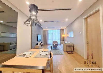 a dining room and living room with a dining table at 188 Suites KLCC by Holma in Kuala Lumpur