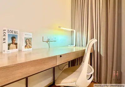 a desk with a lamp and a chair in a room at 188 Suites KLCC by Holma in Kuala Lumpur